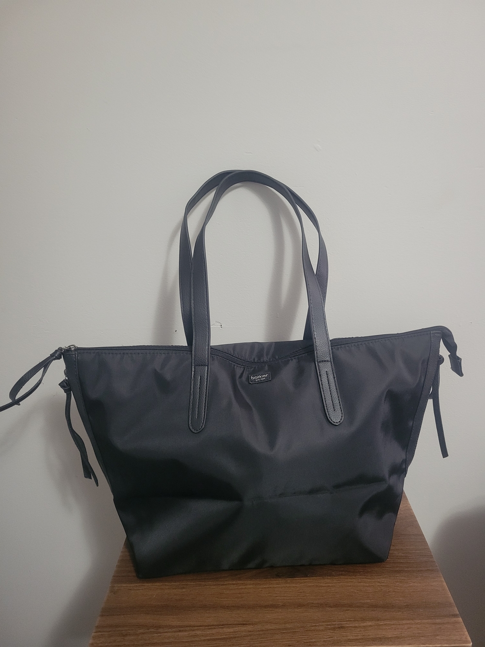 Black nylon Botkier New York tote bag with leather trim and zipper accents.